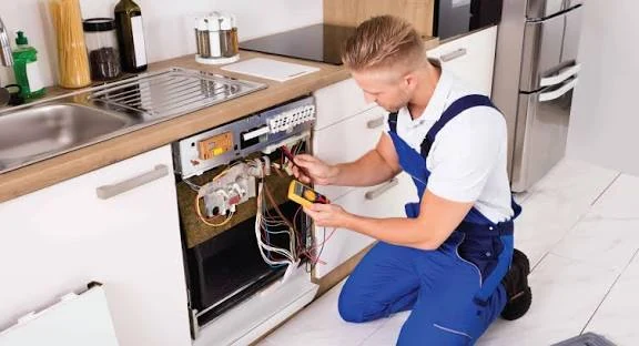 Technician using a multimeter to test dishwasher components