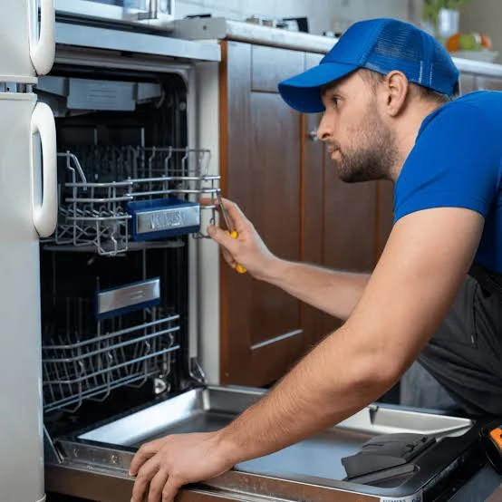 Technician inspecting the racks of an open dishwasher