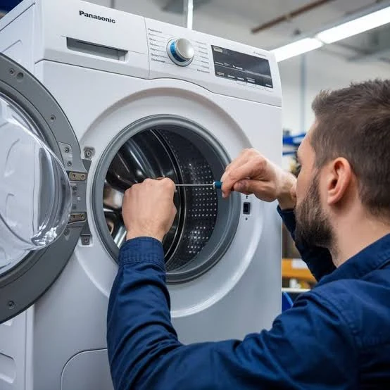 Technician working on the drum of a front-load washing machine
